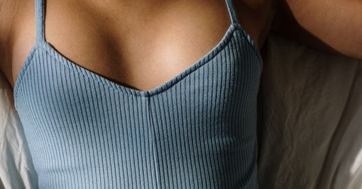 Woman in blue silk sleepwear relaxing peacefully in morning light — complete guide to buying silk sleepwear online Australia Calliope Studio