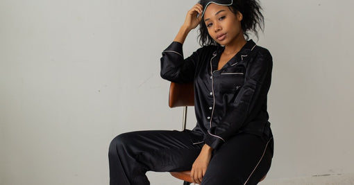 Woman in luxurious black mulberry silk pyjamas with sleep mask — why Calliope Studio only uses mulberry silk Australia
