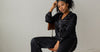 Woman in luxurious black mulberry silk pyjamas with sleep mask — why Calliope Studio only uses mulberry silk Australia
